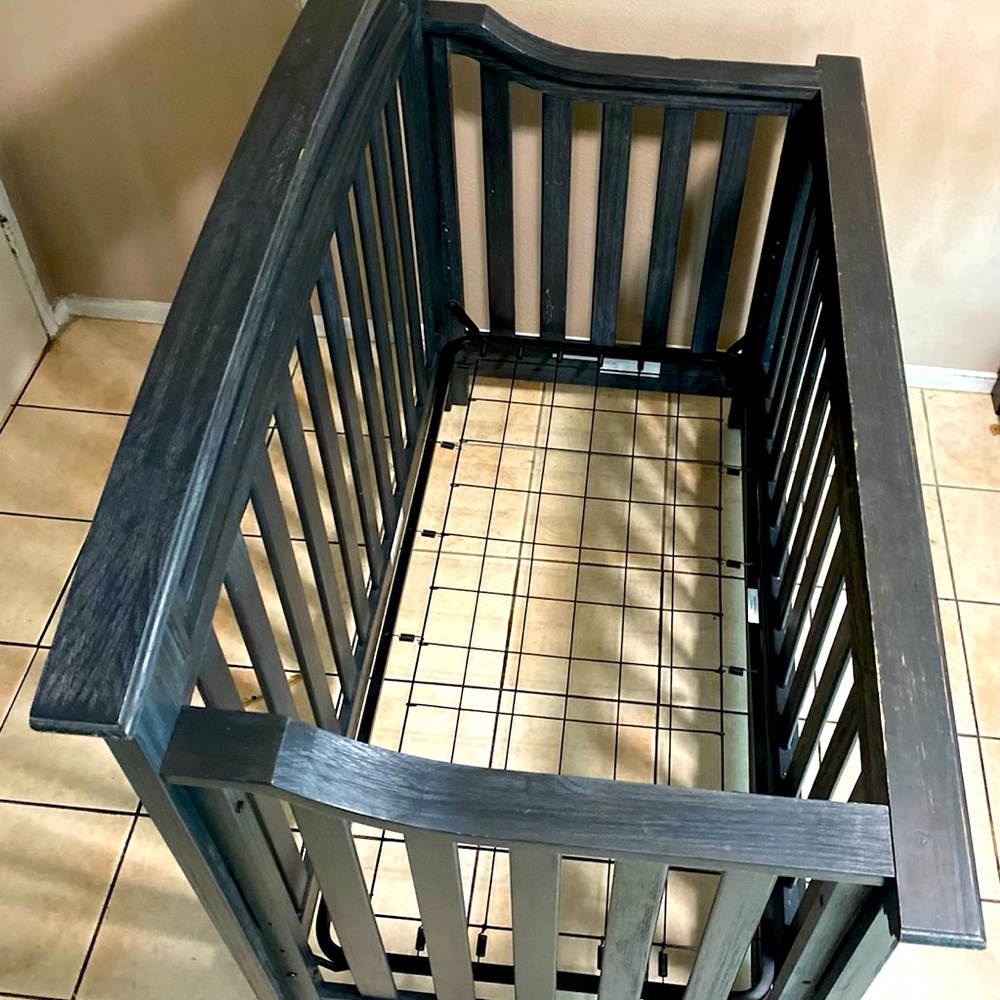 This antique crib upsizes. Transforms to a regular bed